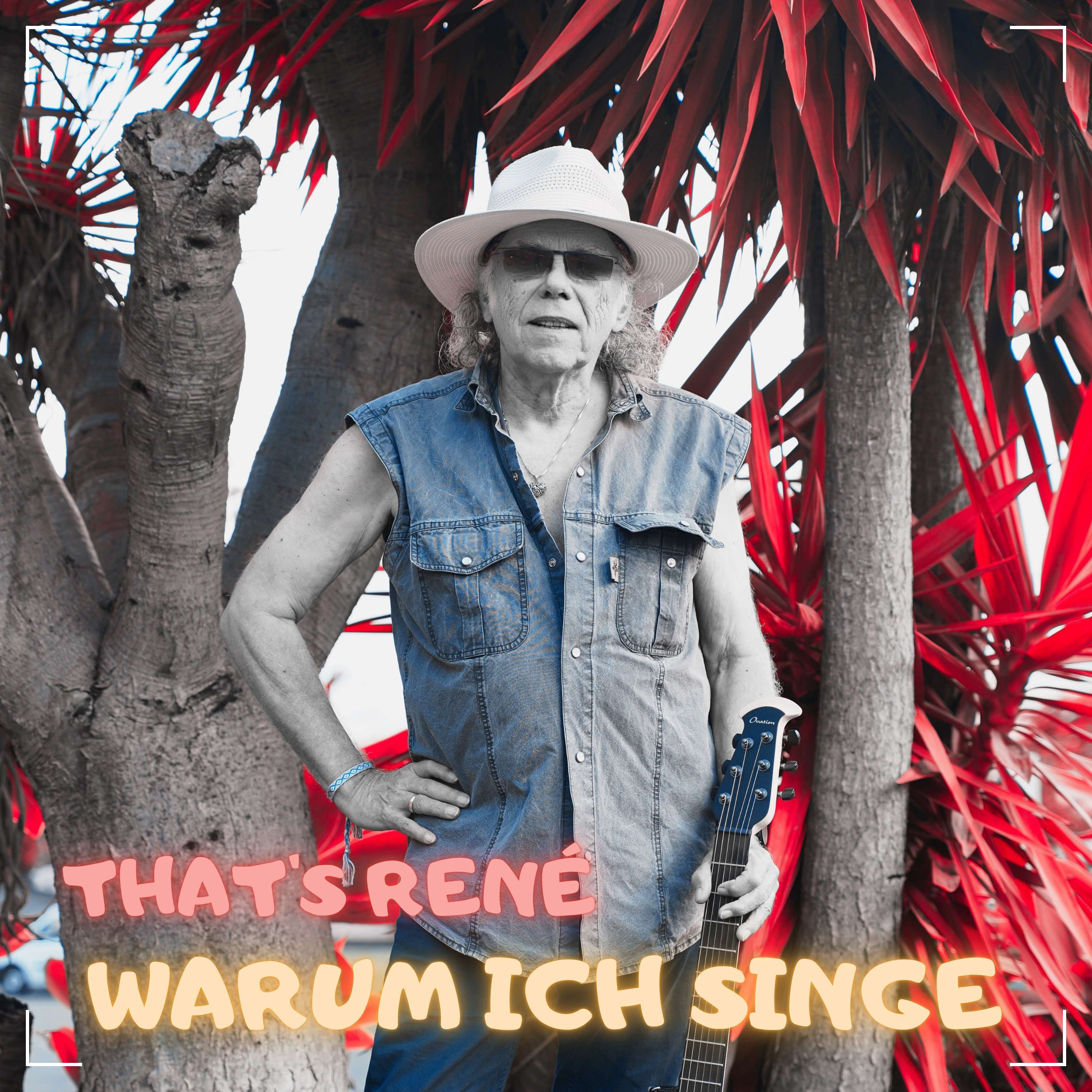 a man in a hat is standing in front of a tree