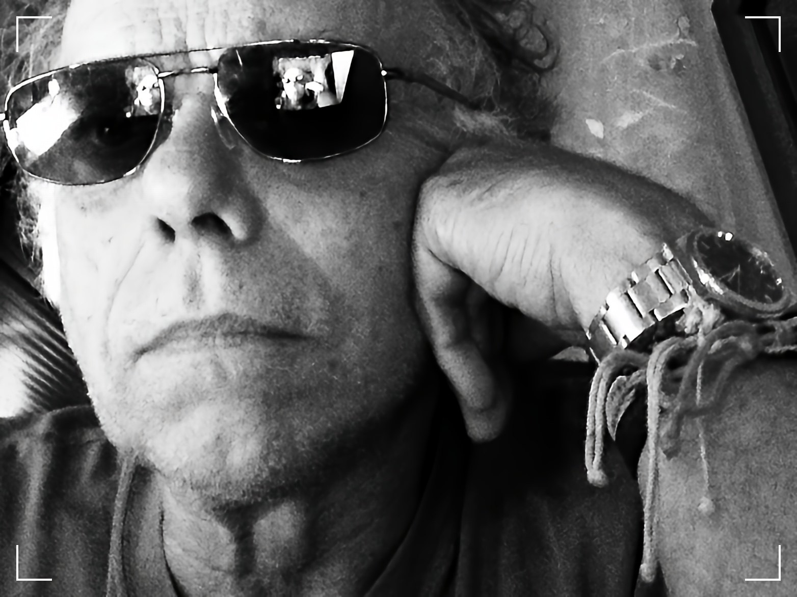 a black and white photo of a man wearing sunglasses