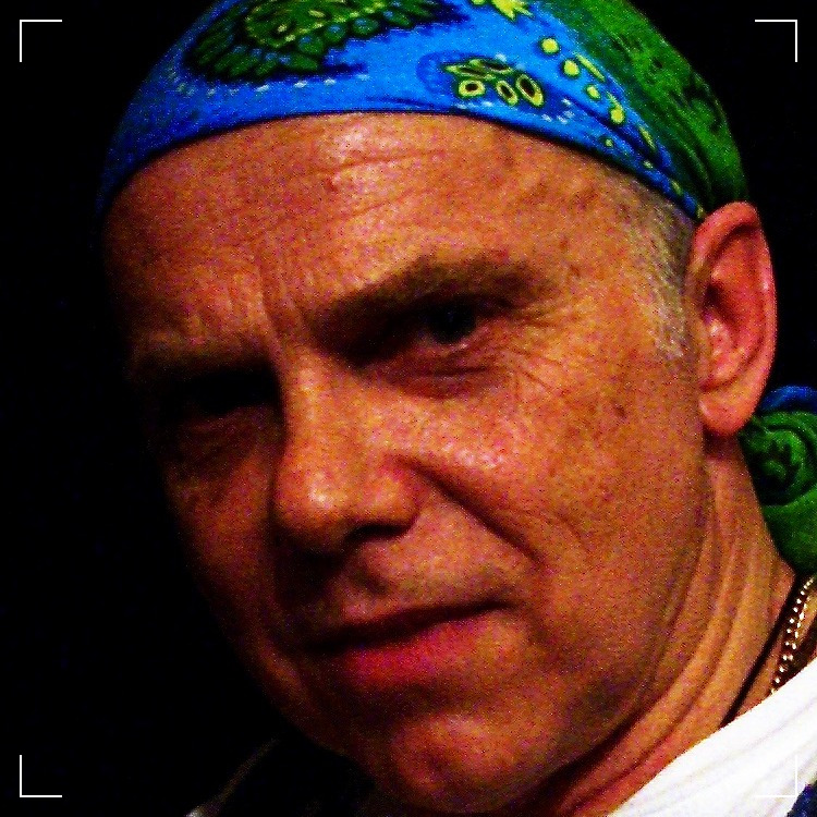 a man wearing a blue and green bandana