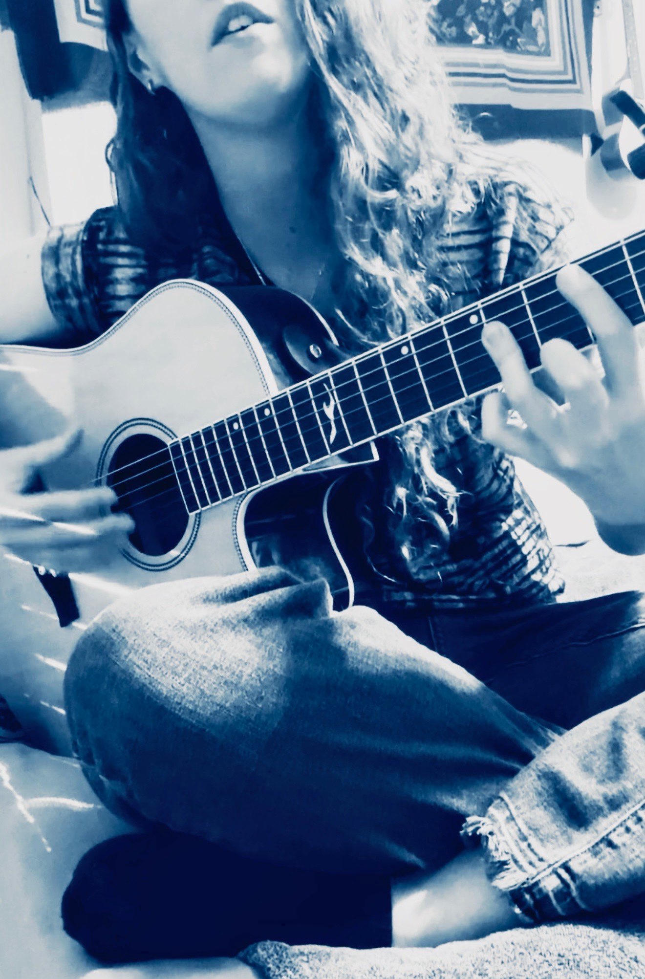 a girl playing an acoustic guitar