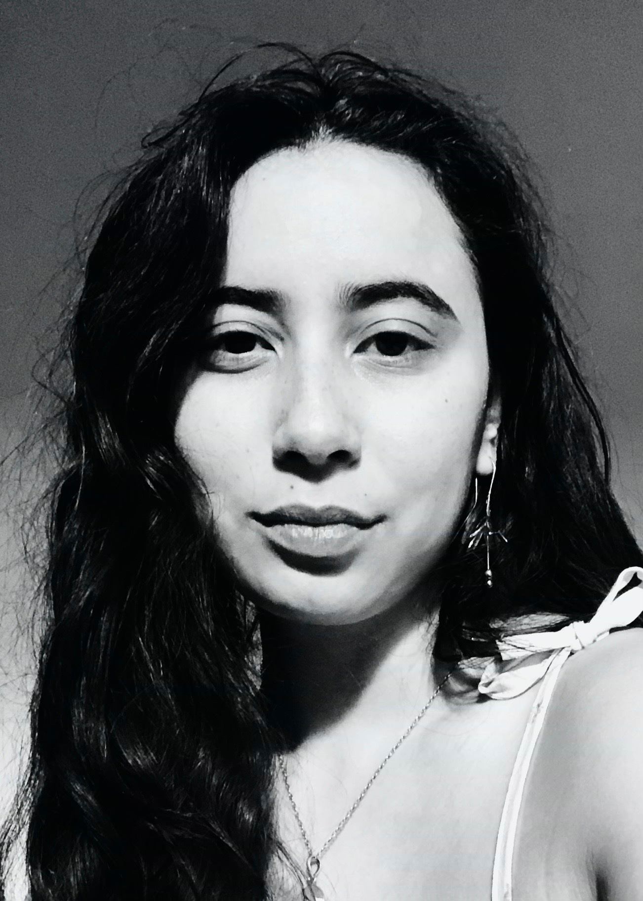 a black and white photo of a woman with long hair