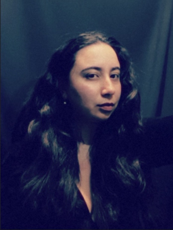 a woman with long hair is taking a selfie