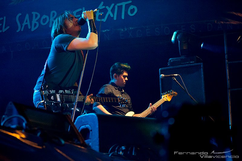 a man singing on stage with a microphone