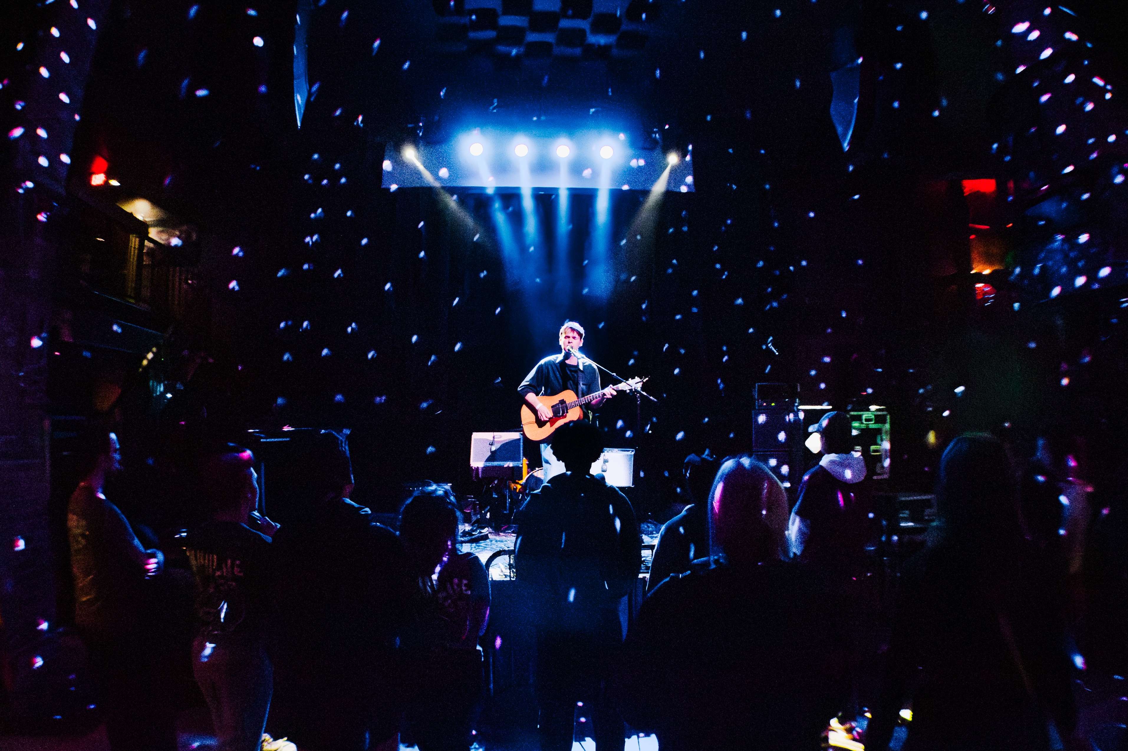 a group of people playing music in a dark room