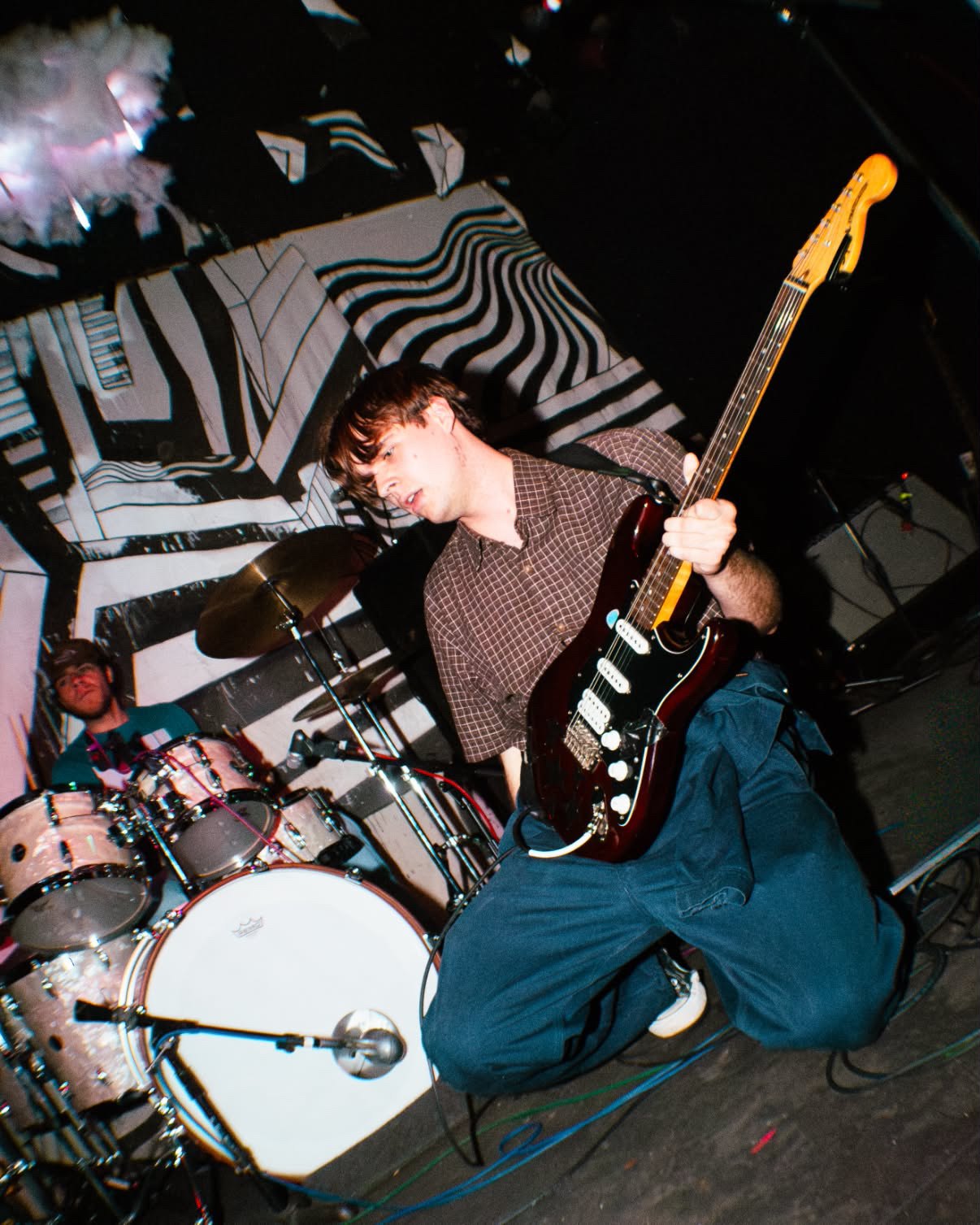 a man playing a guitar on a stage