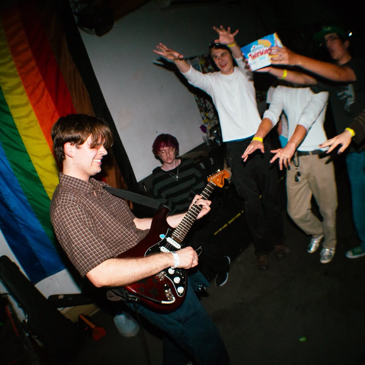 a man playing a guitar at a party