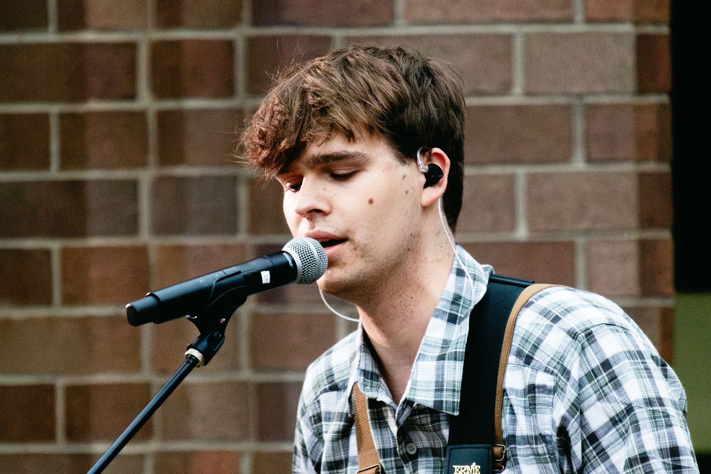 a young man singing into a microphone