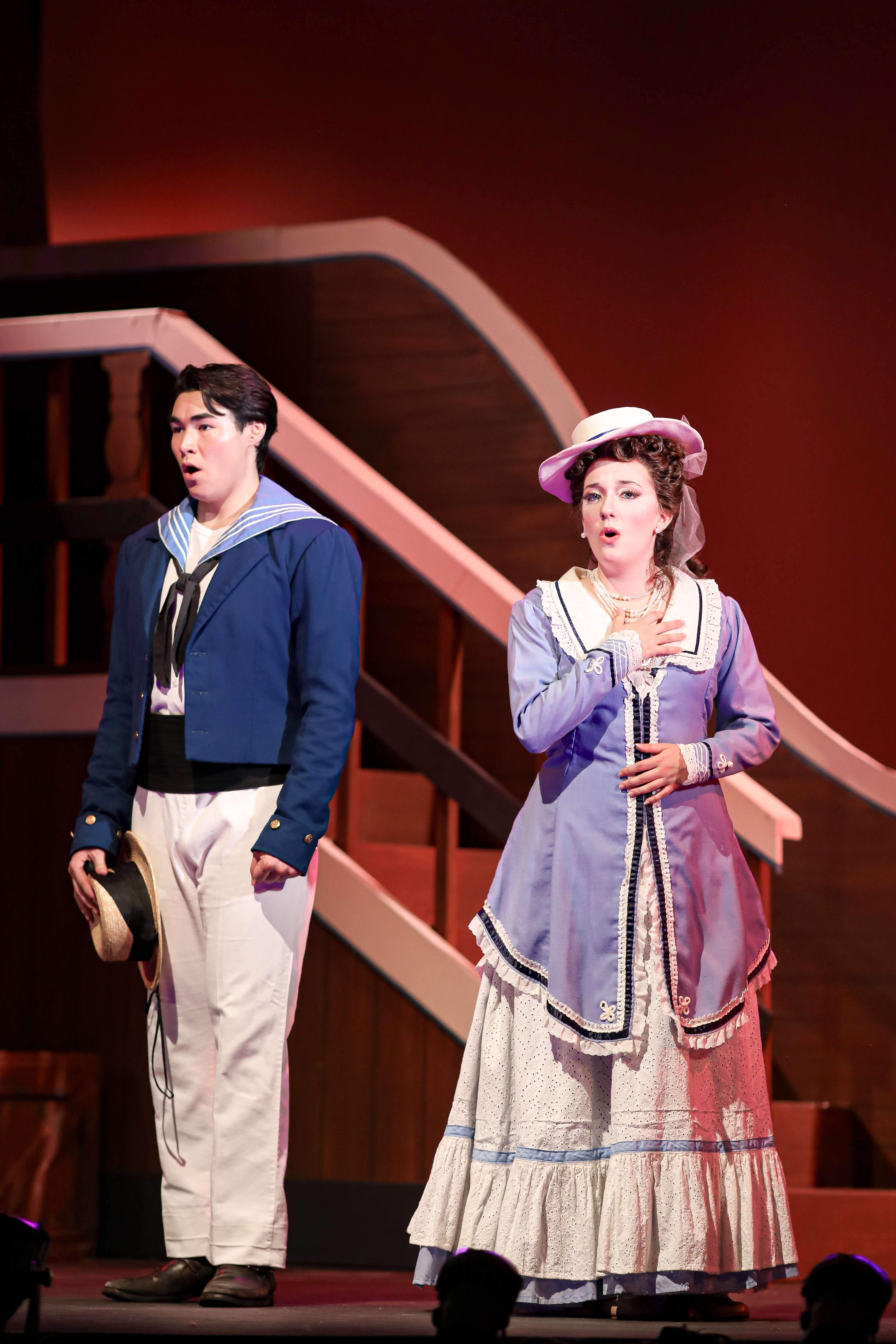 a man and a woman dressed in a sailor costume on stage