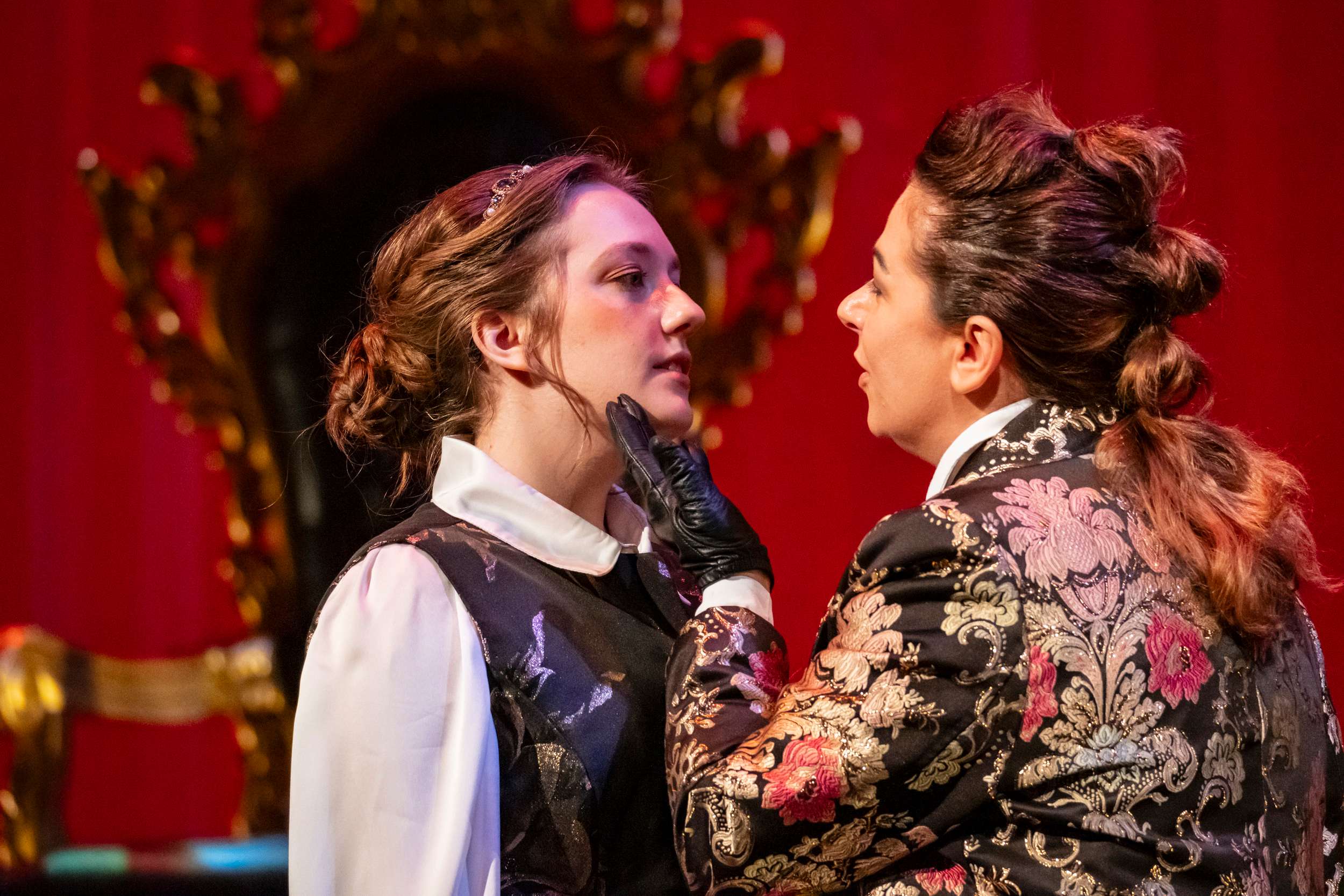 a woman is talking to another woman in a costume