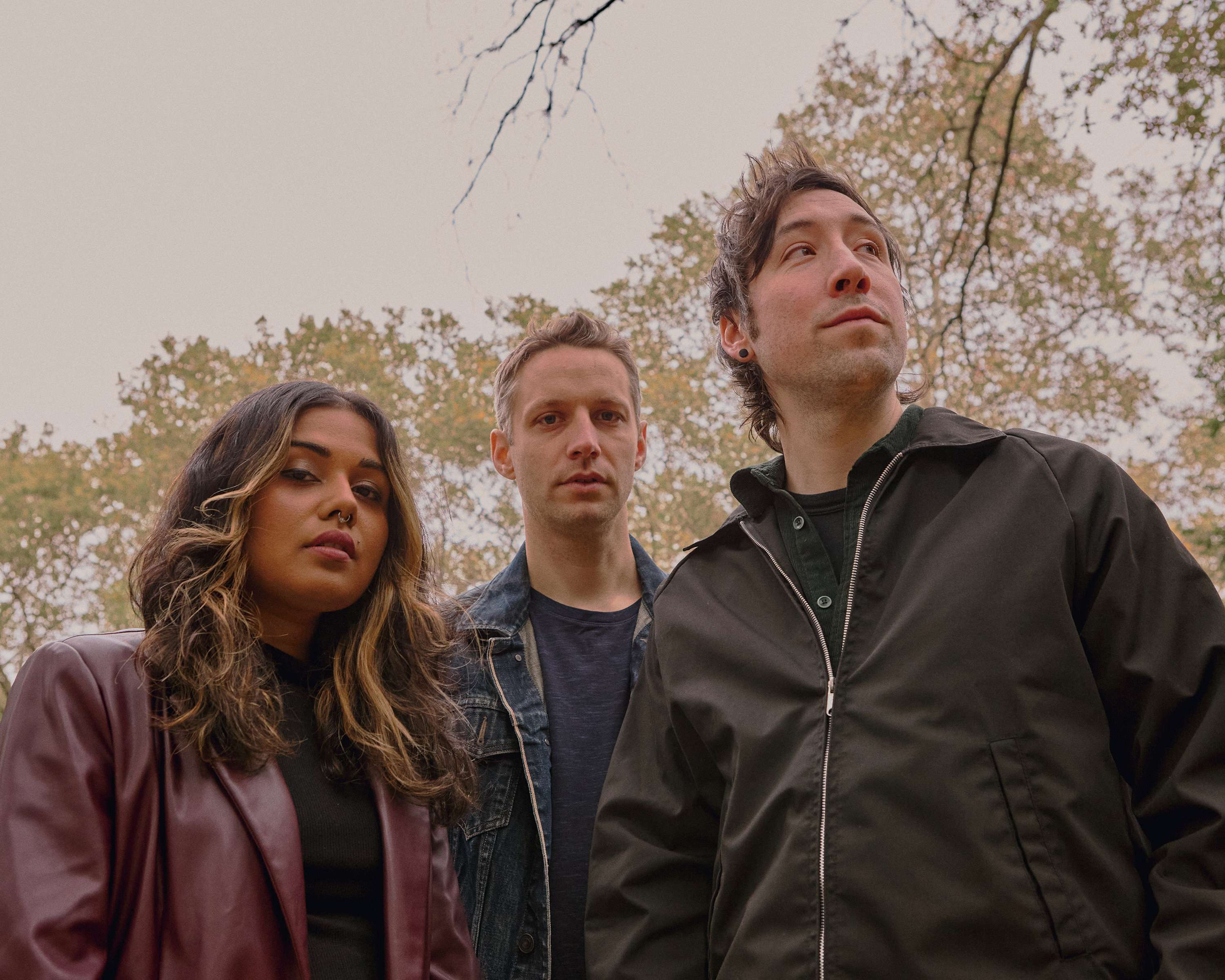a group of people standing in a wooded area