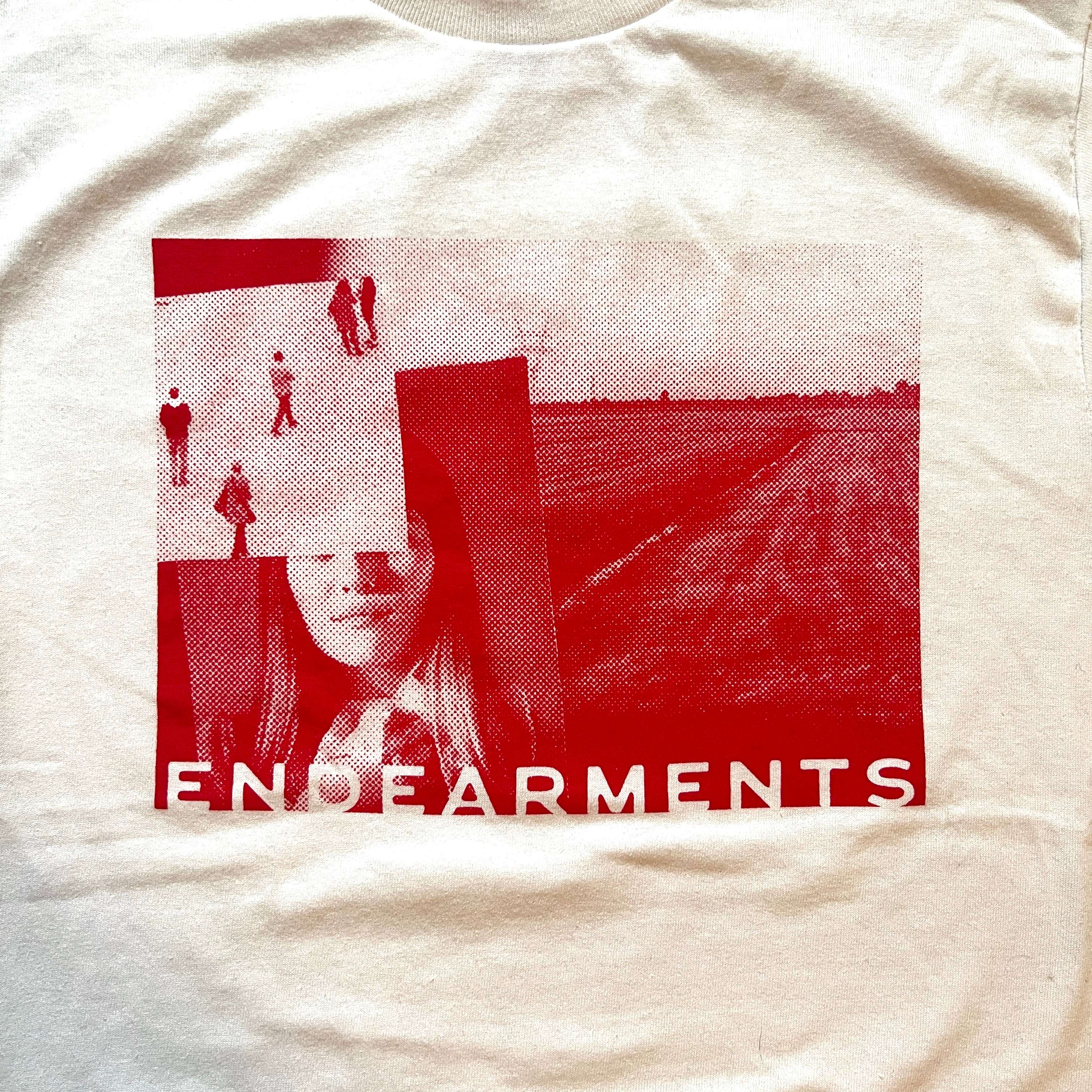 a white t - shirt with an image of a woman and a man