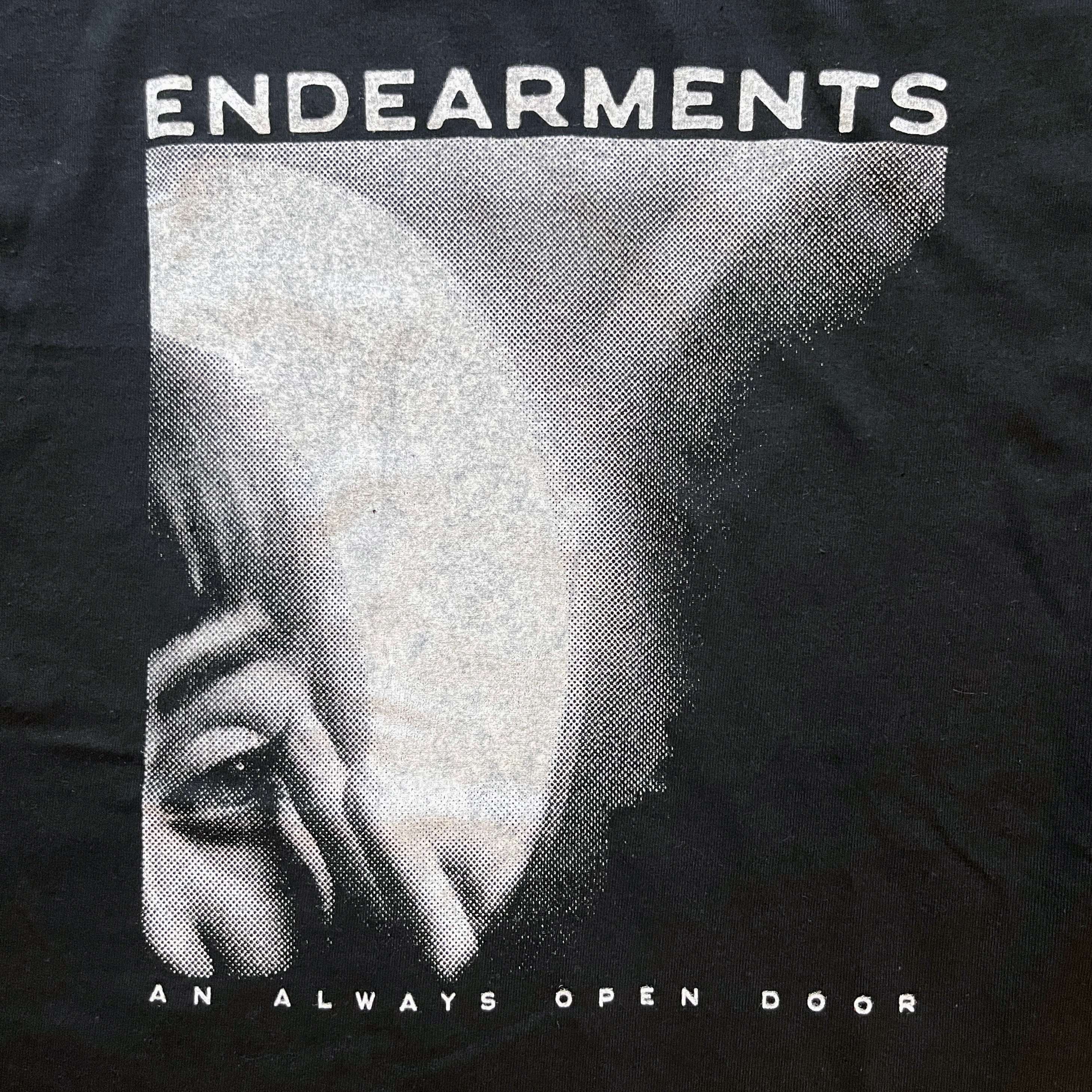 a black t - shirt with the words endearments an always open door