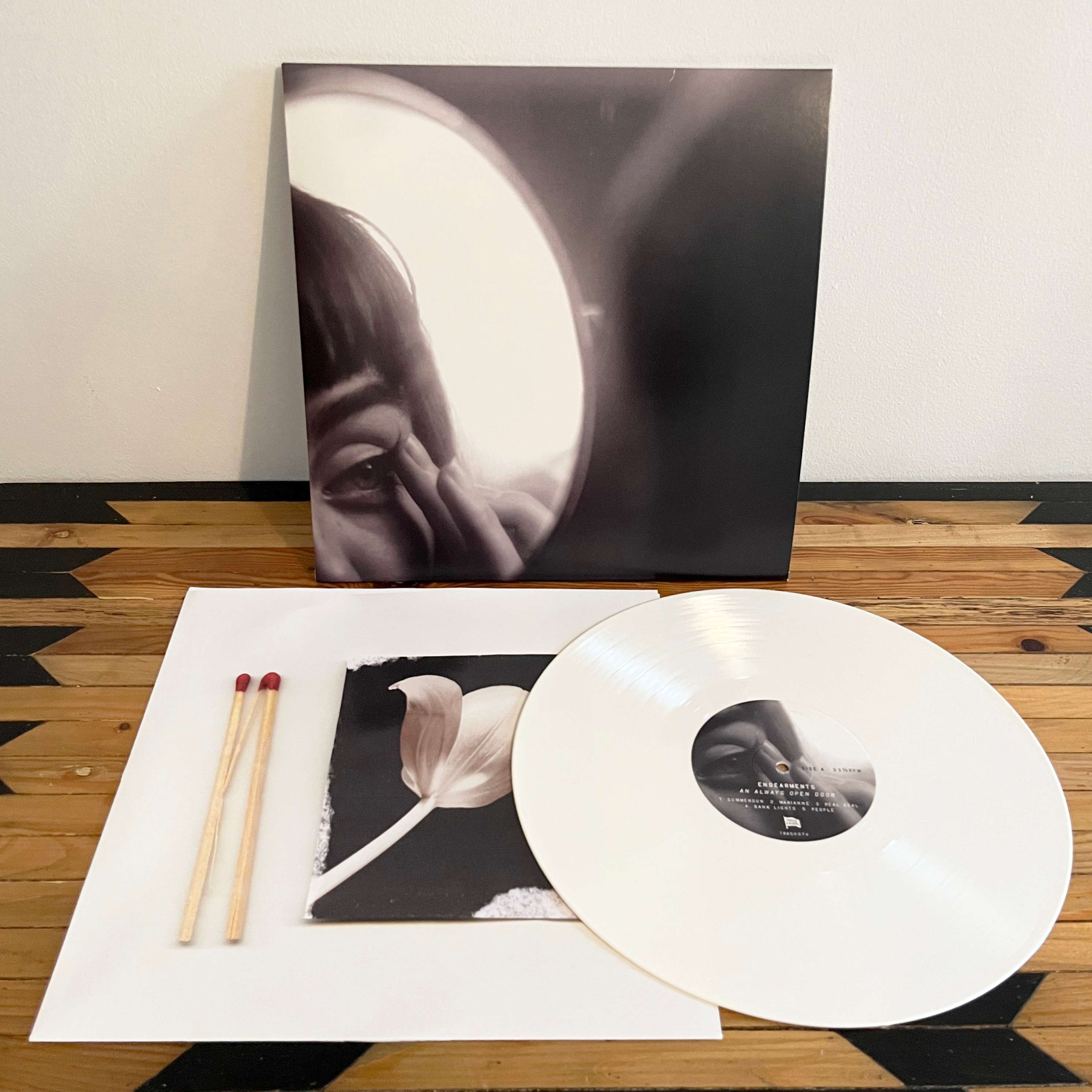 a white lp with a picture of a woman and a match