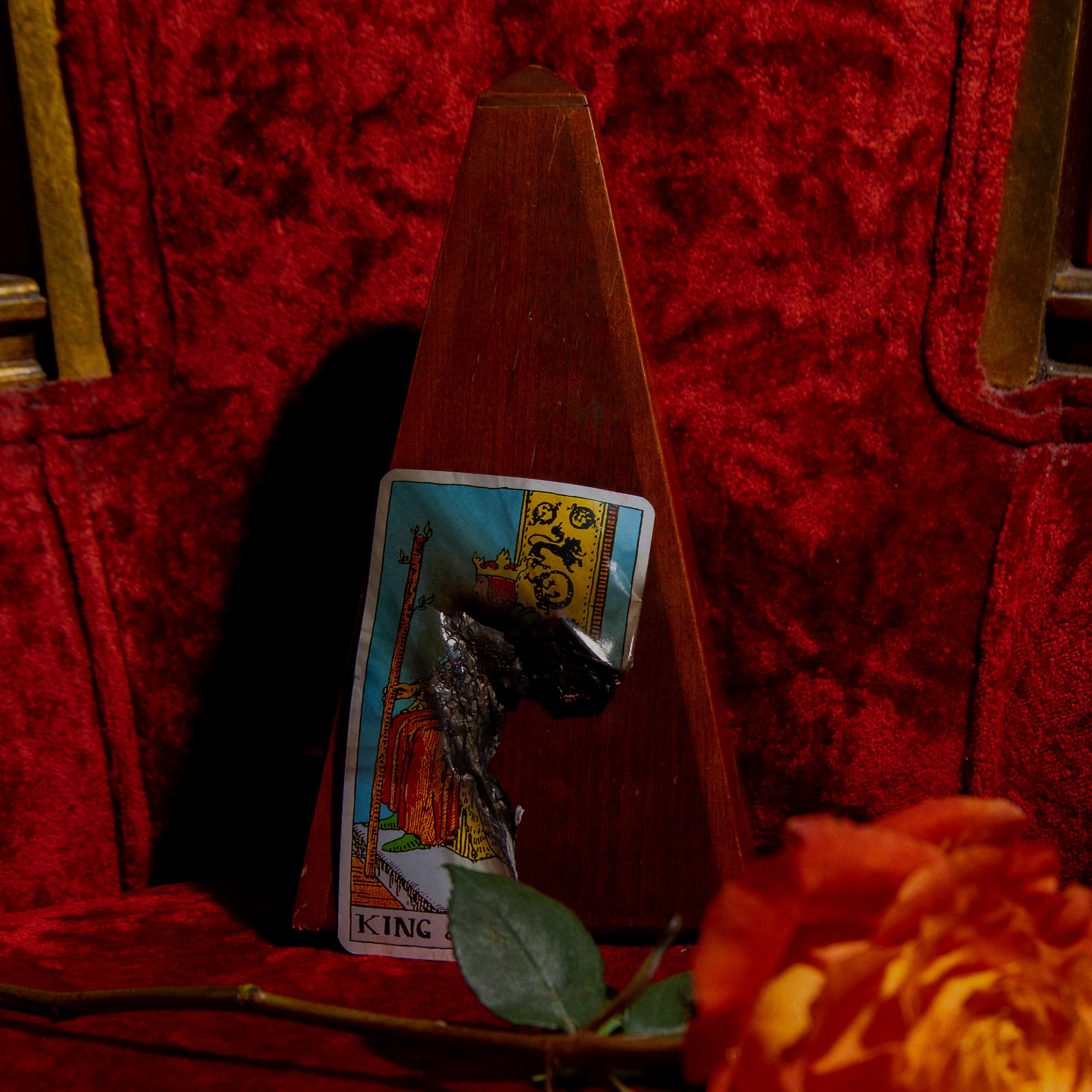 a tarot card is sitting on top of a red chair
