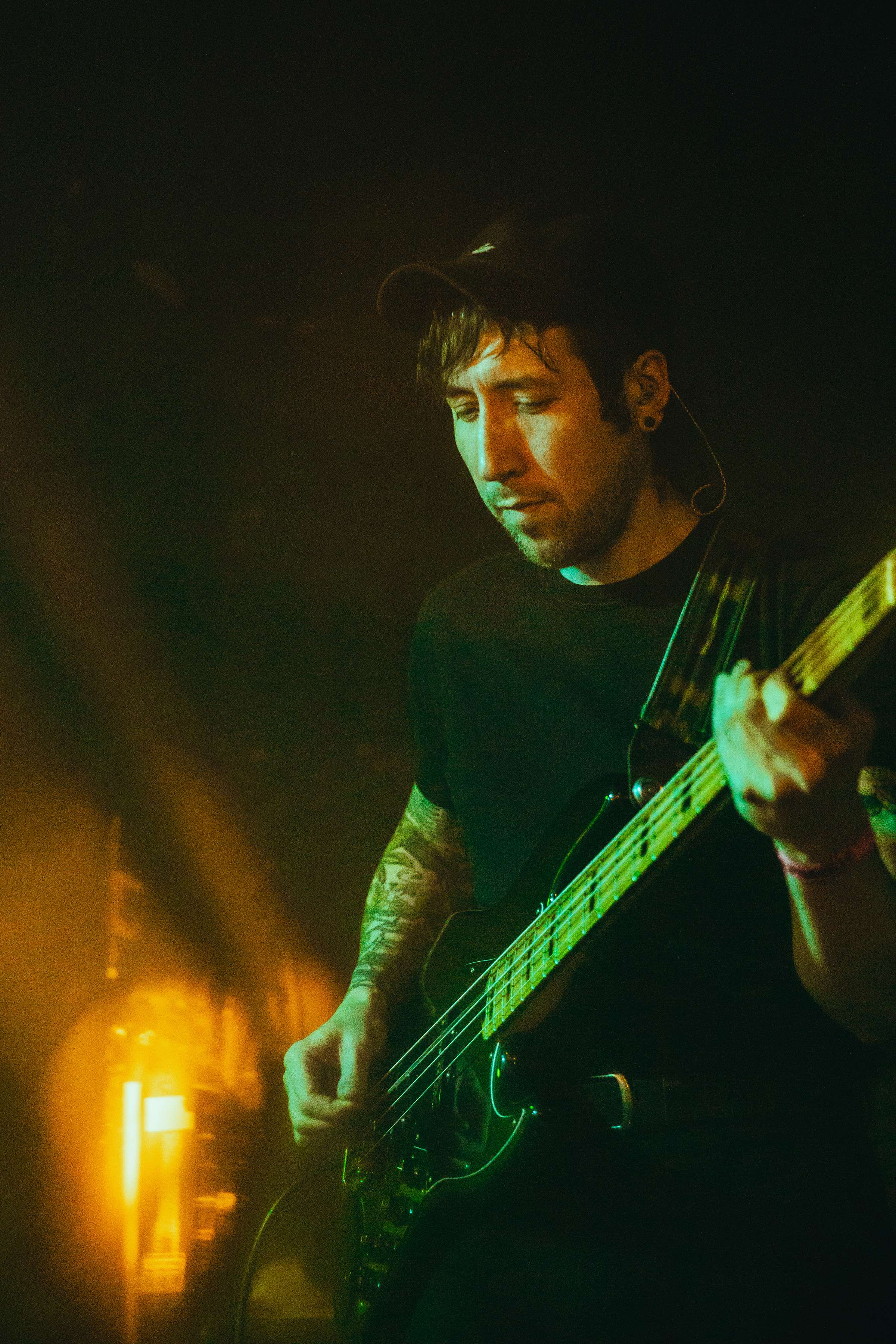 a man playing a bass at a concert