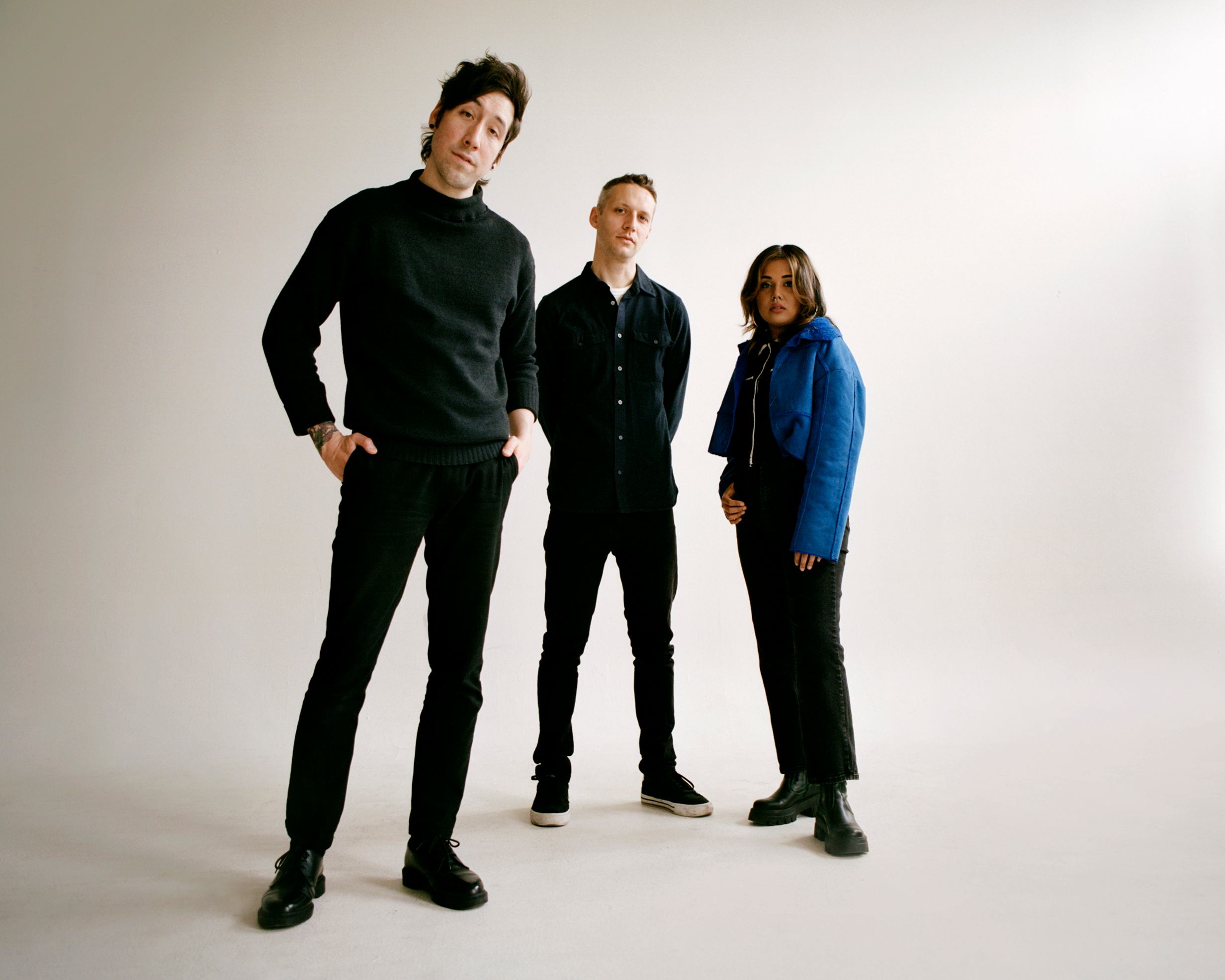 a group of people posing for a photo in a studio