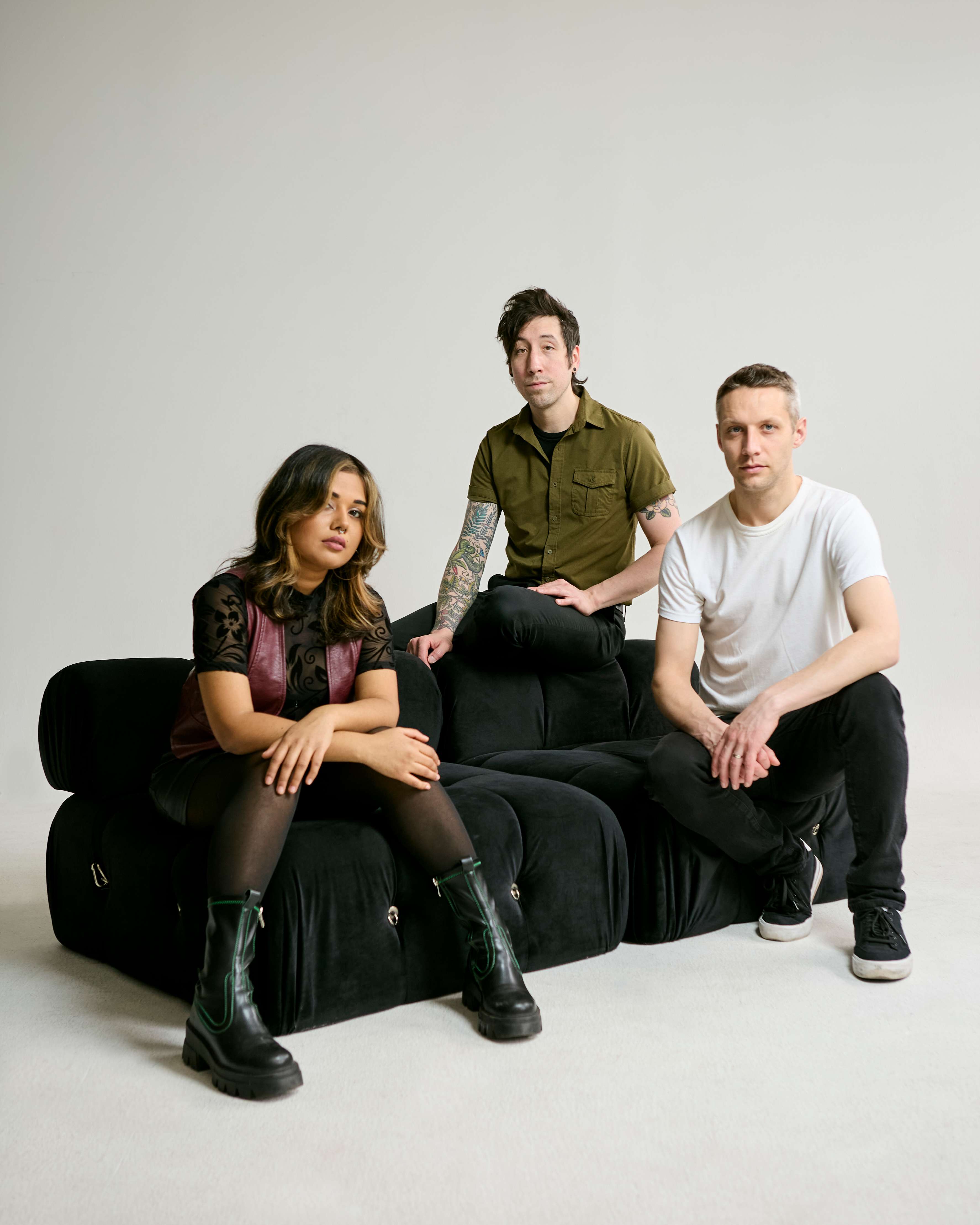 a group of people sitting on a black couch
