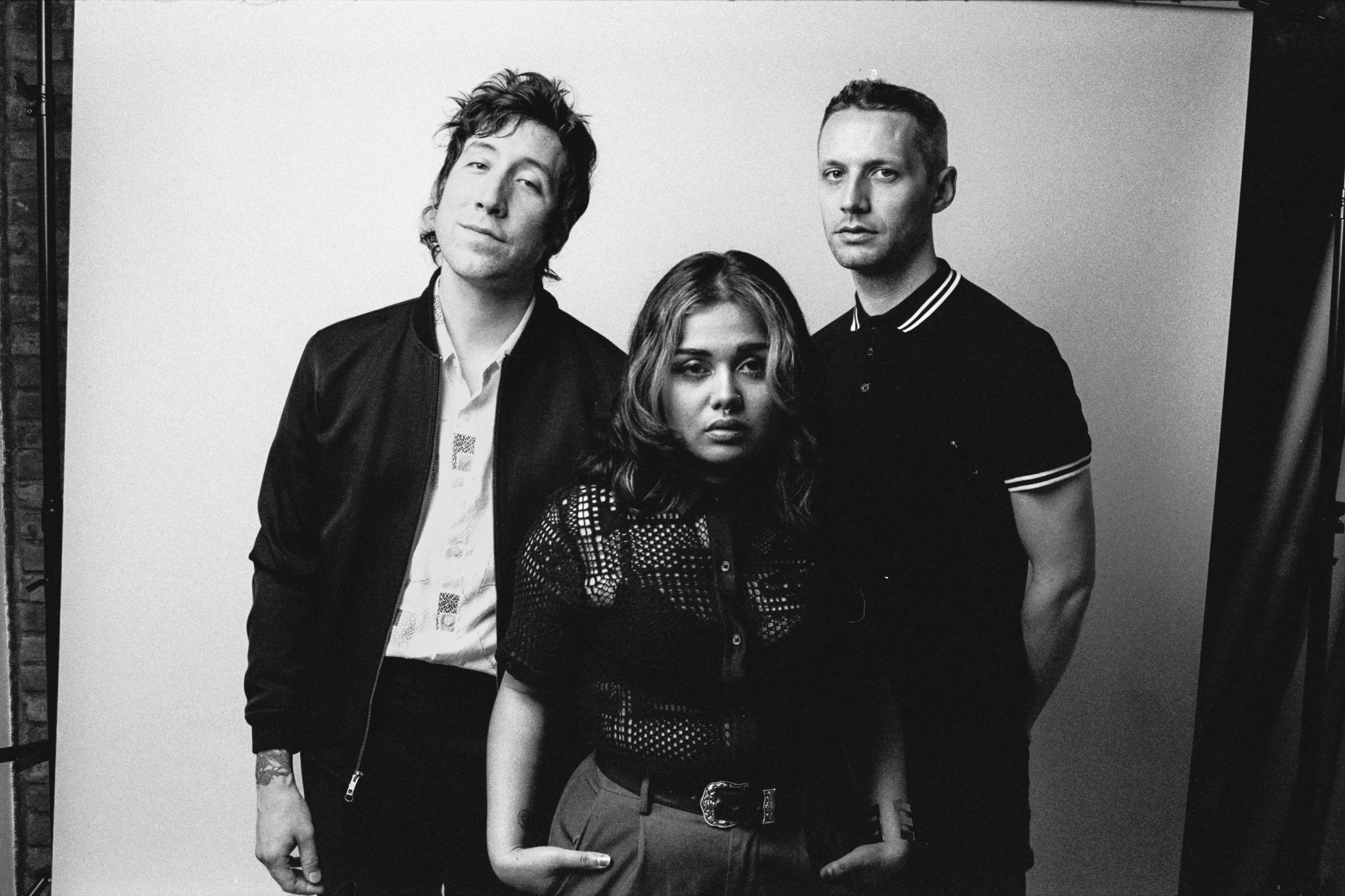 a black and white photo of a group of people posing for a photo