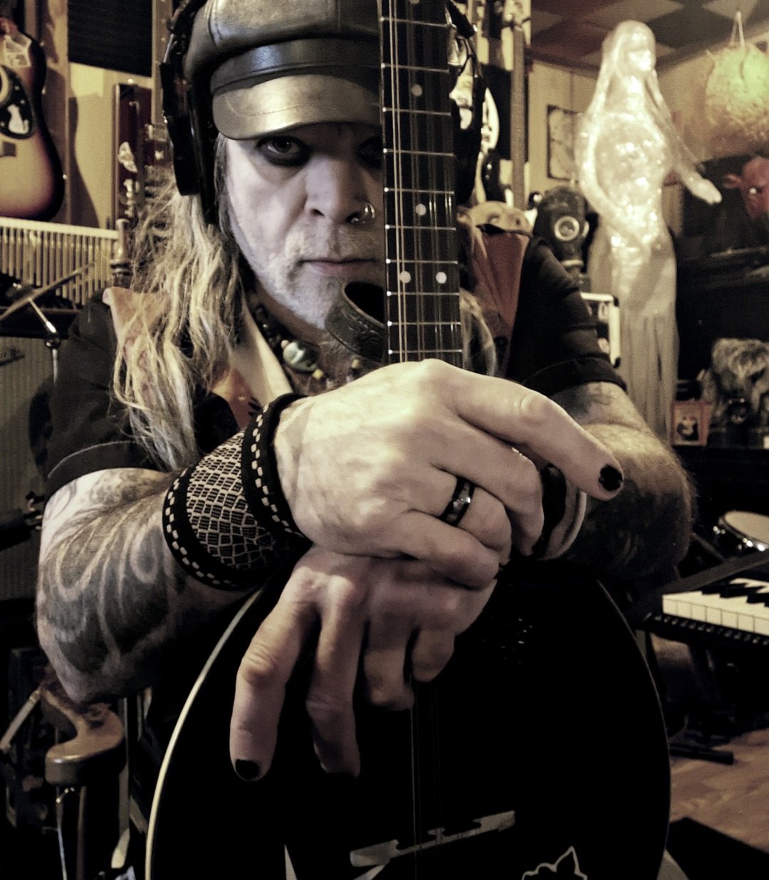 a man wearing a hat holding a guitar