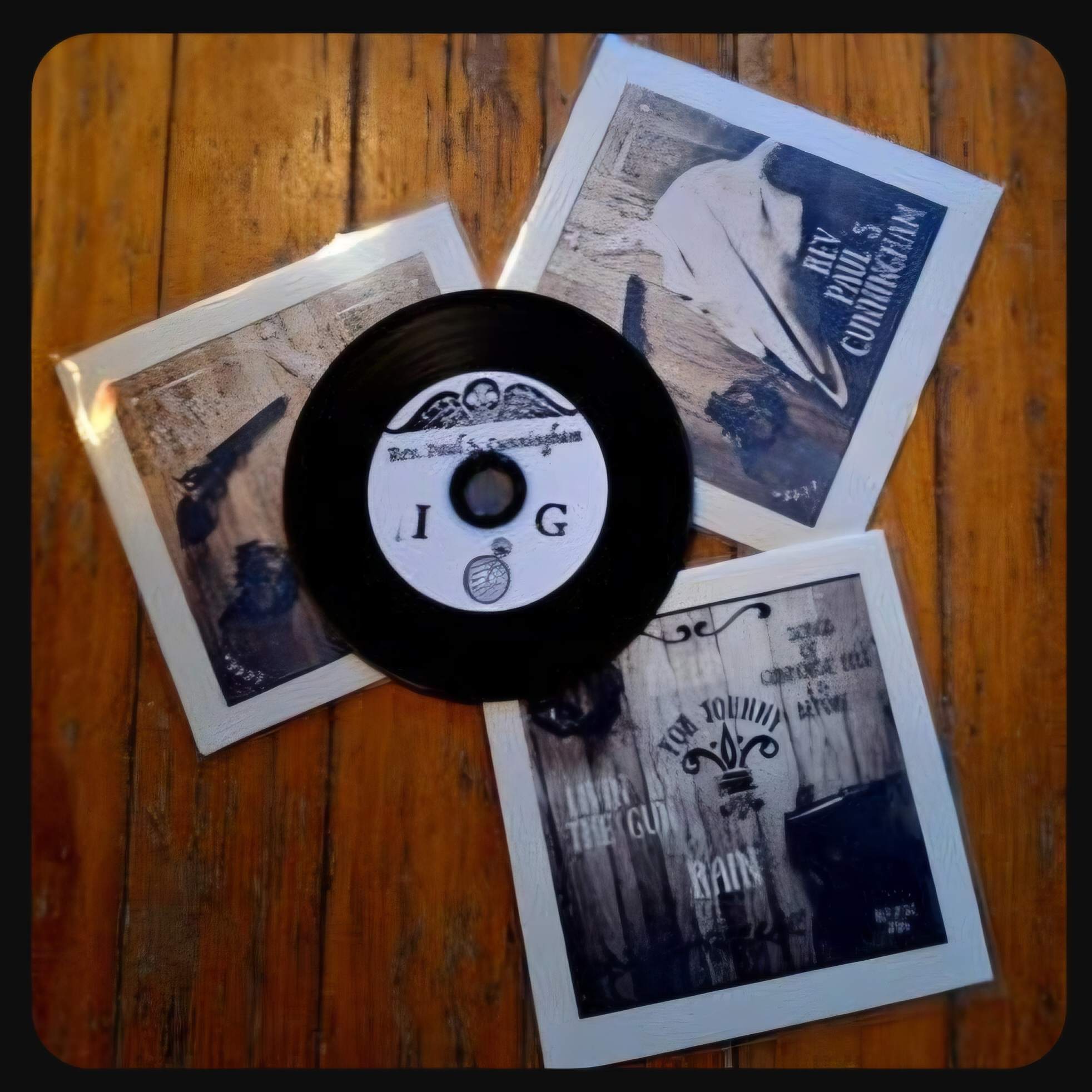a black and white picture of a cd and a picture of a cd