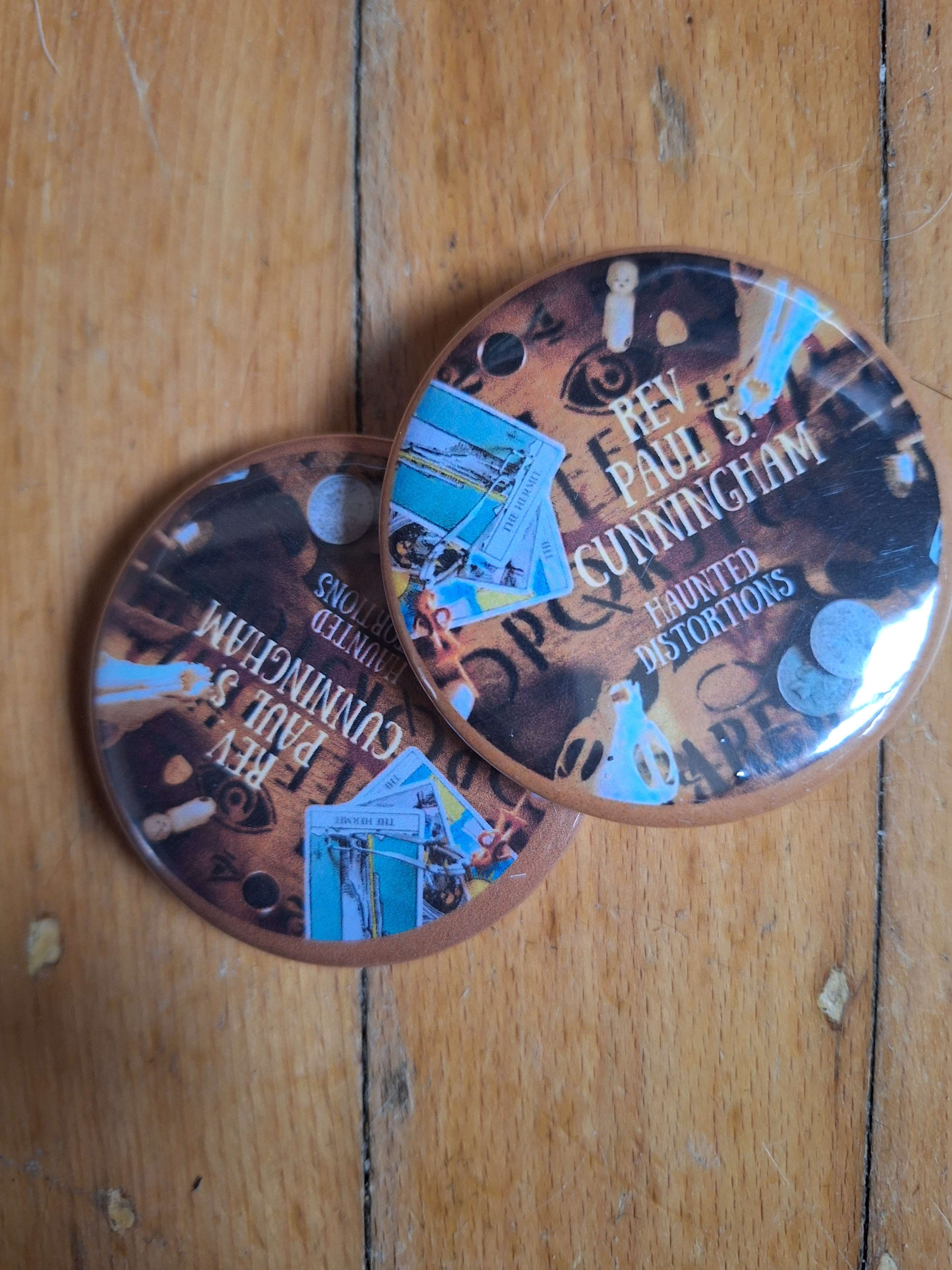 two buttons on a wooden floor
