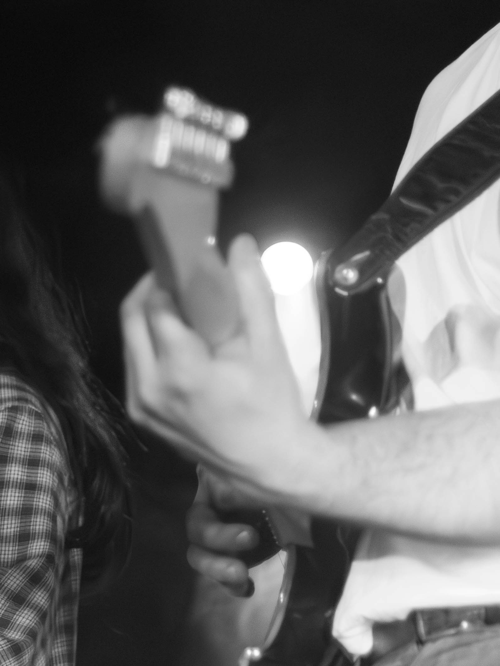 black and white photo of a man playing a guitar