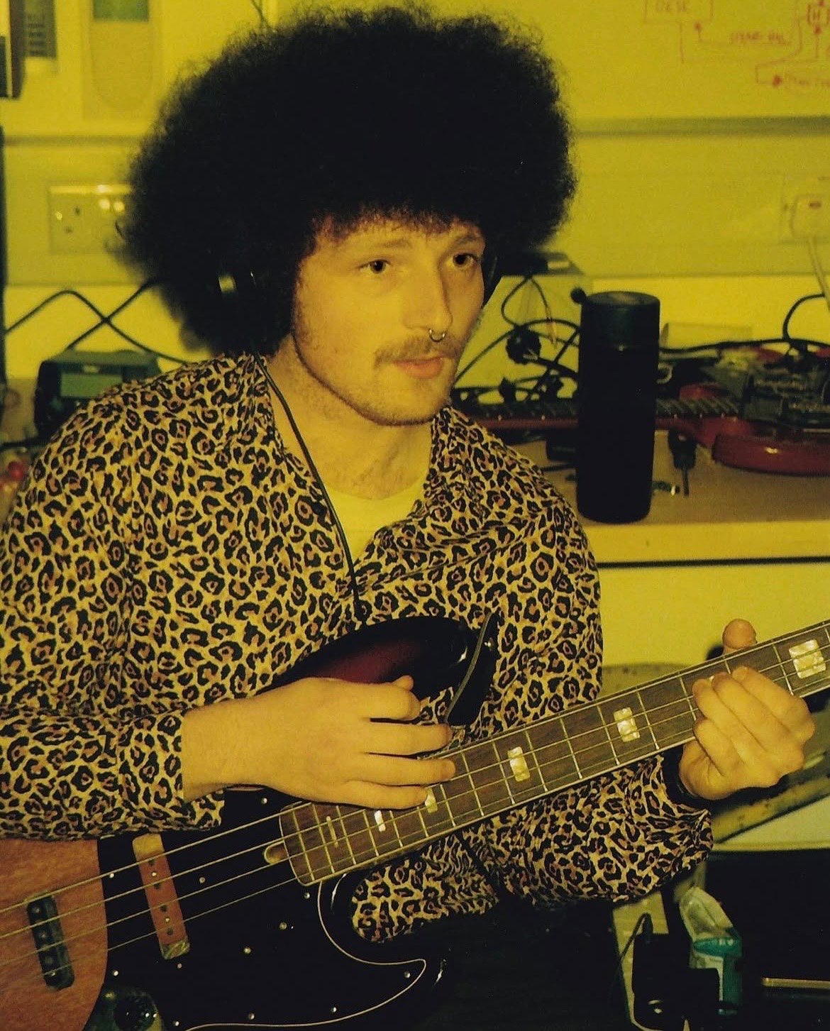 a man with an afro playing a bass