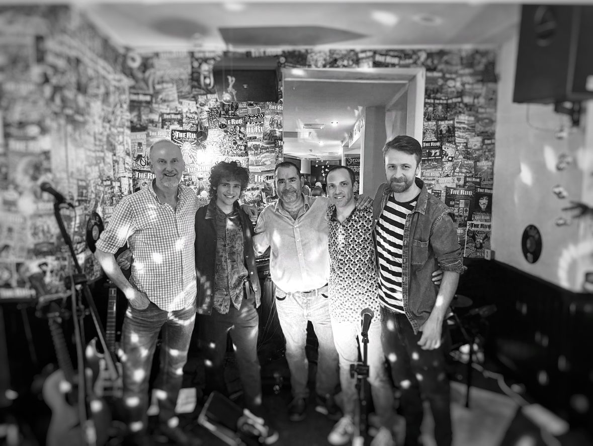 a black and white photo of a group of people in a room