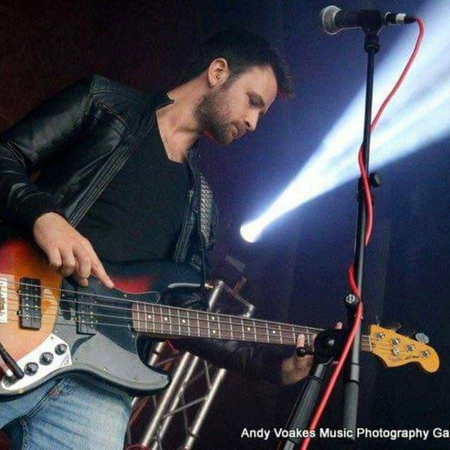 image may contain person, playing a musical instrument, on stage and guitar