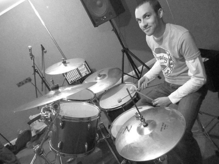 a man playing drums in a recording studio