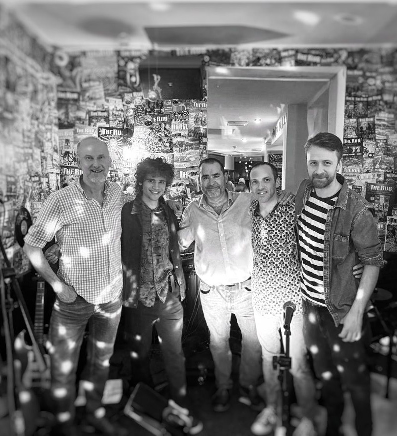a black and white photo of a group of men in a room