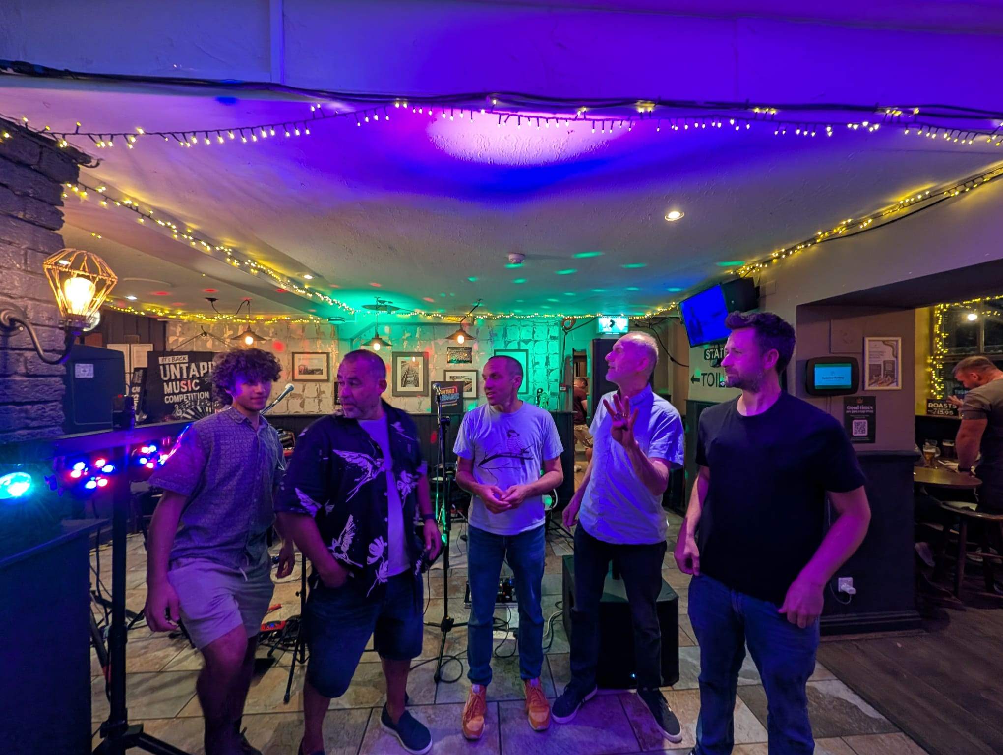 a group of people standing in front of a bar