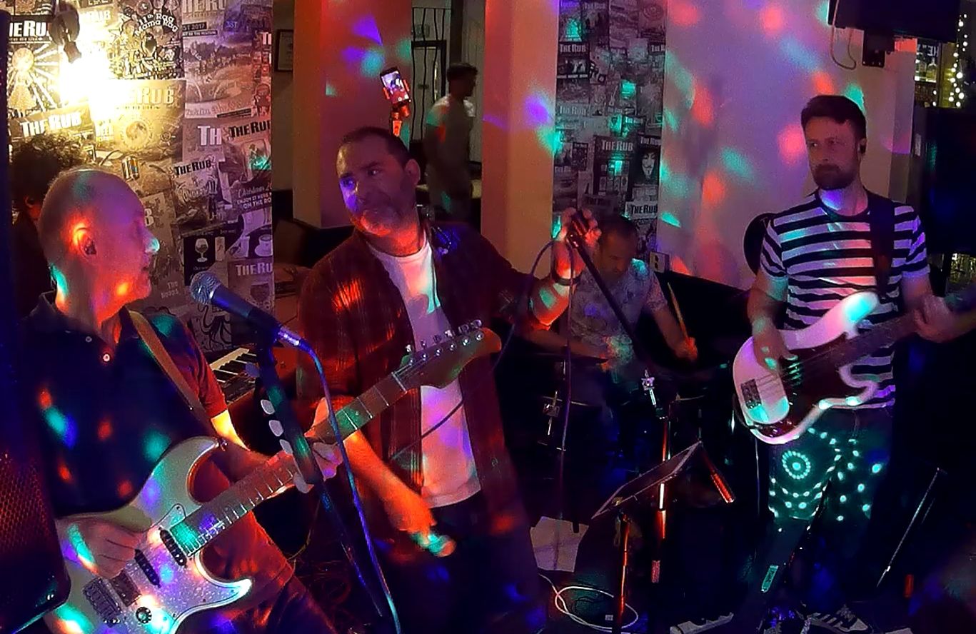 a group of people playing music in a bar