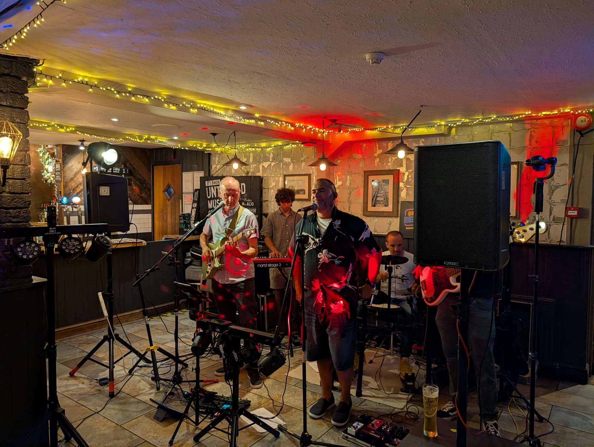a group of people playing music in a bar