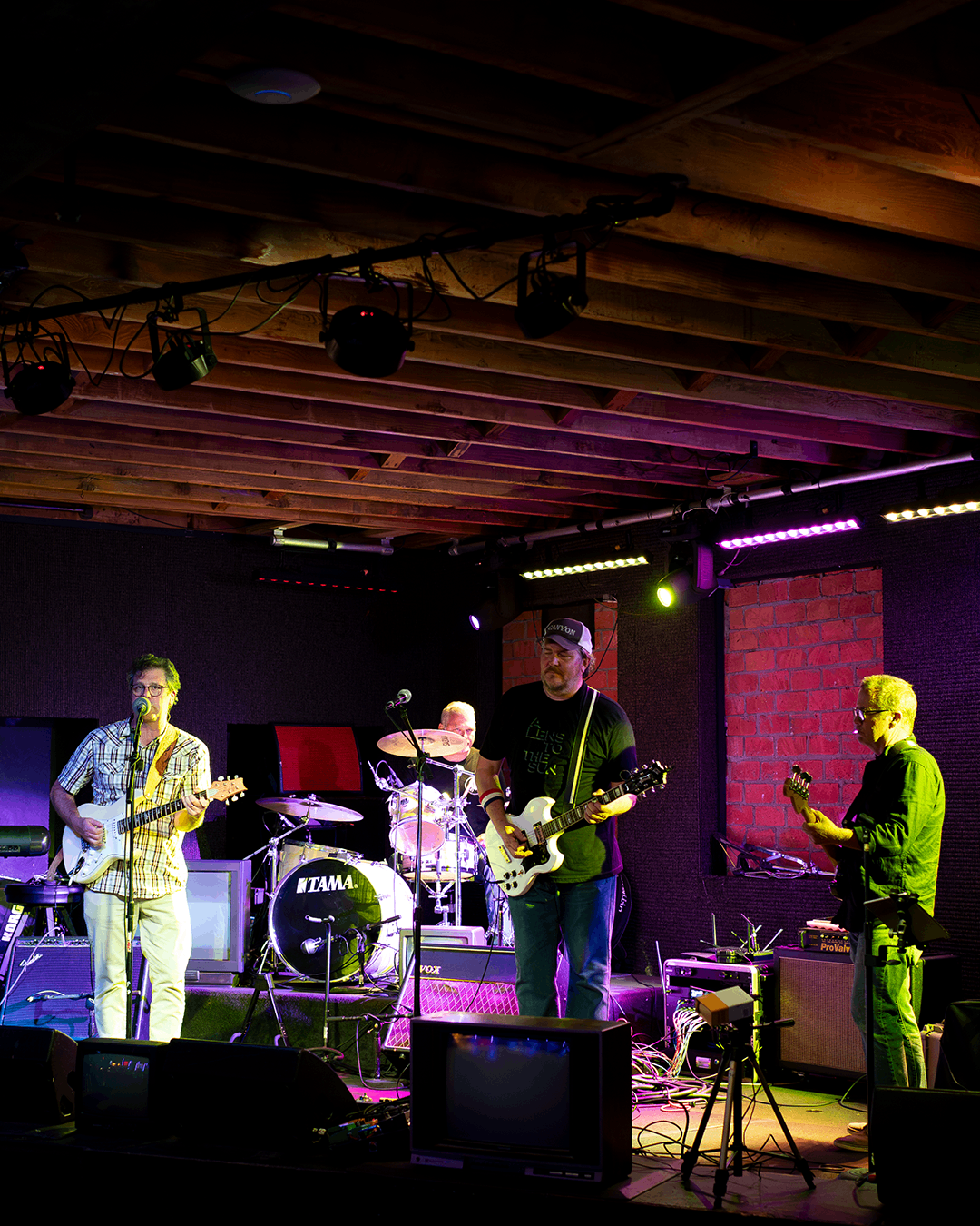 a group of people playing music in a dark room