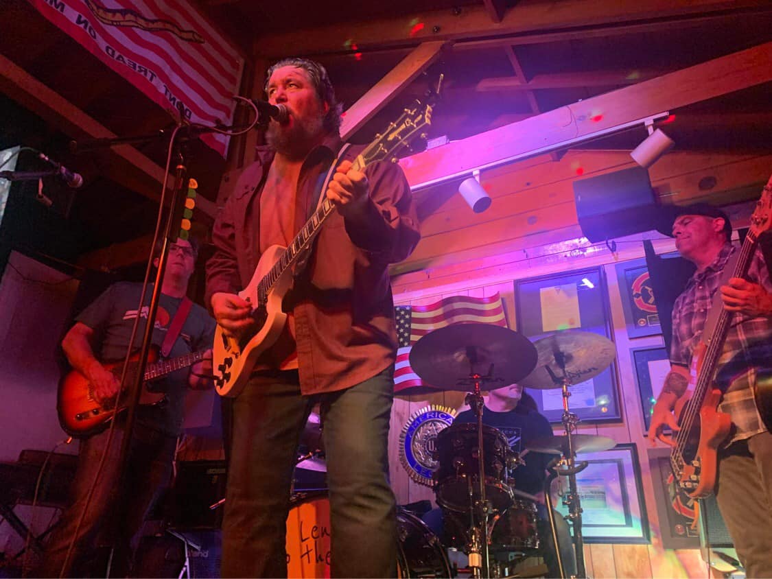a group of men playing music in a bar