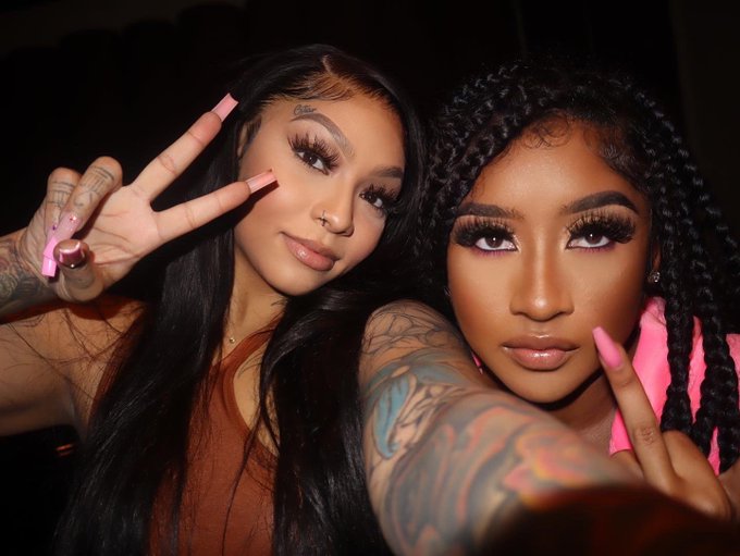 two women with tattoos posing for a photo