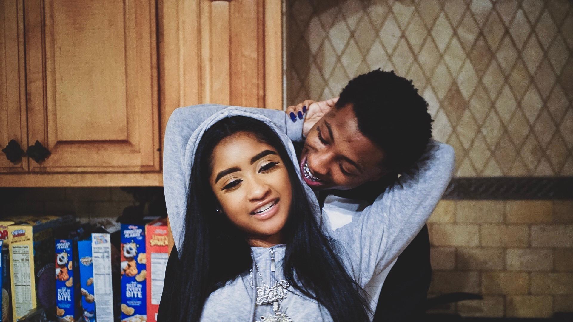 a man and woman hugging in a kitchen