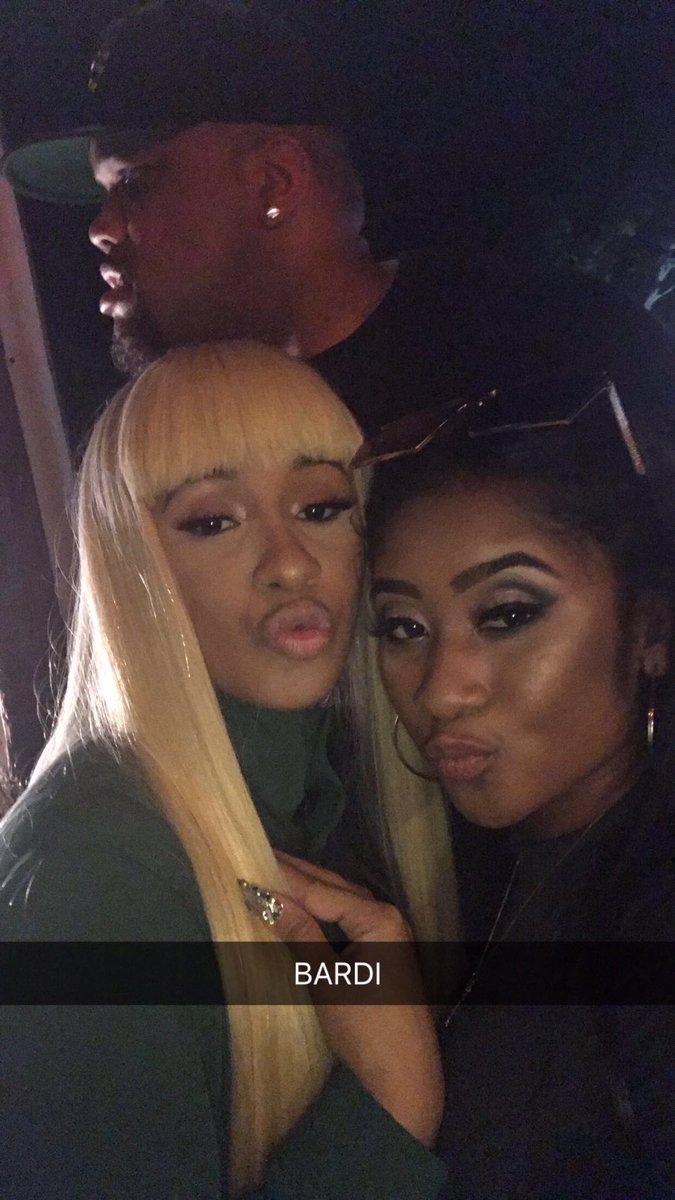 two women posing for a picture with a man