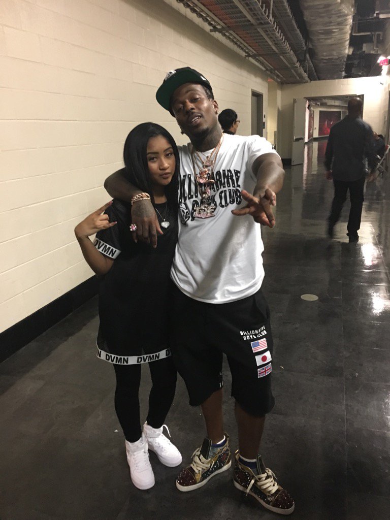 a man and woman standing next to each other in a hallway