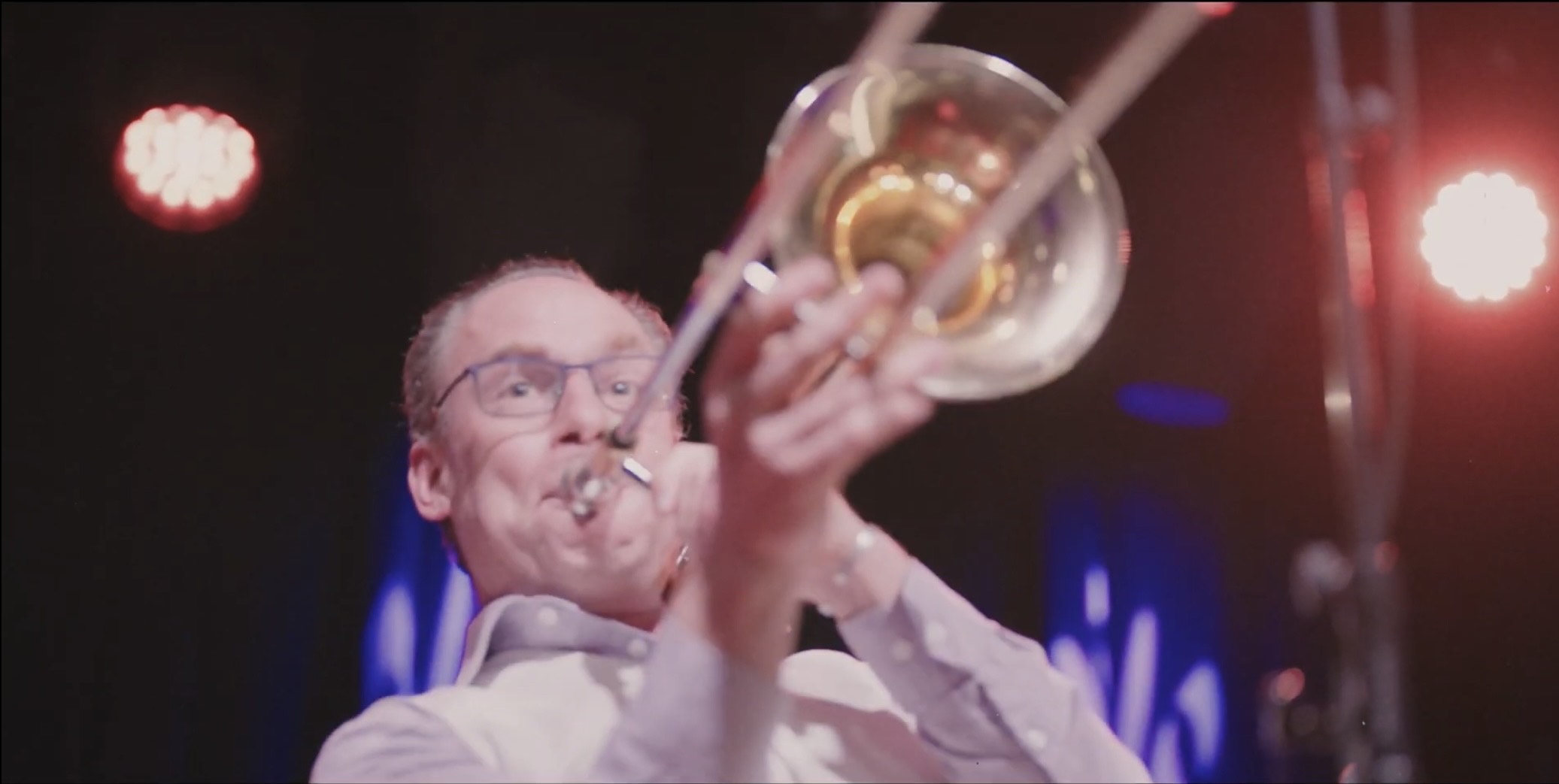 a man playing a trombone on stage