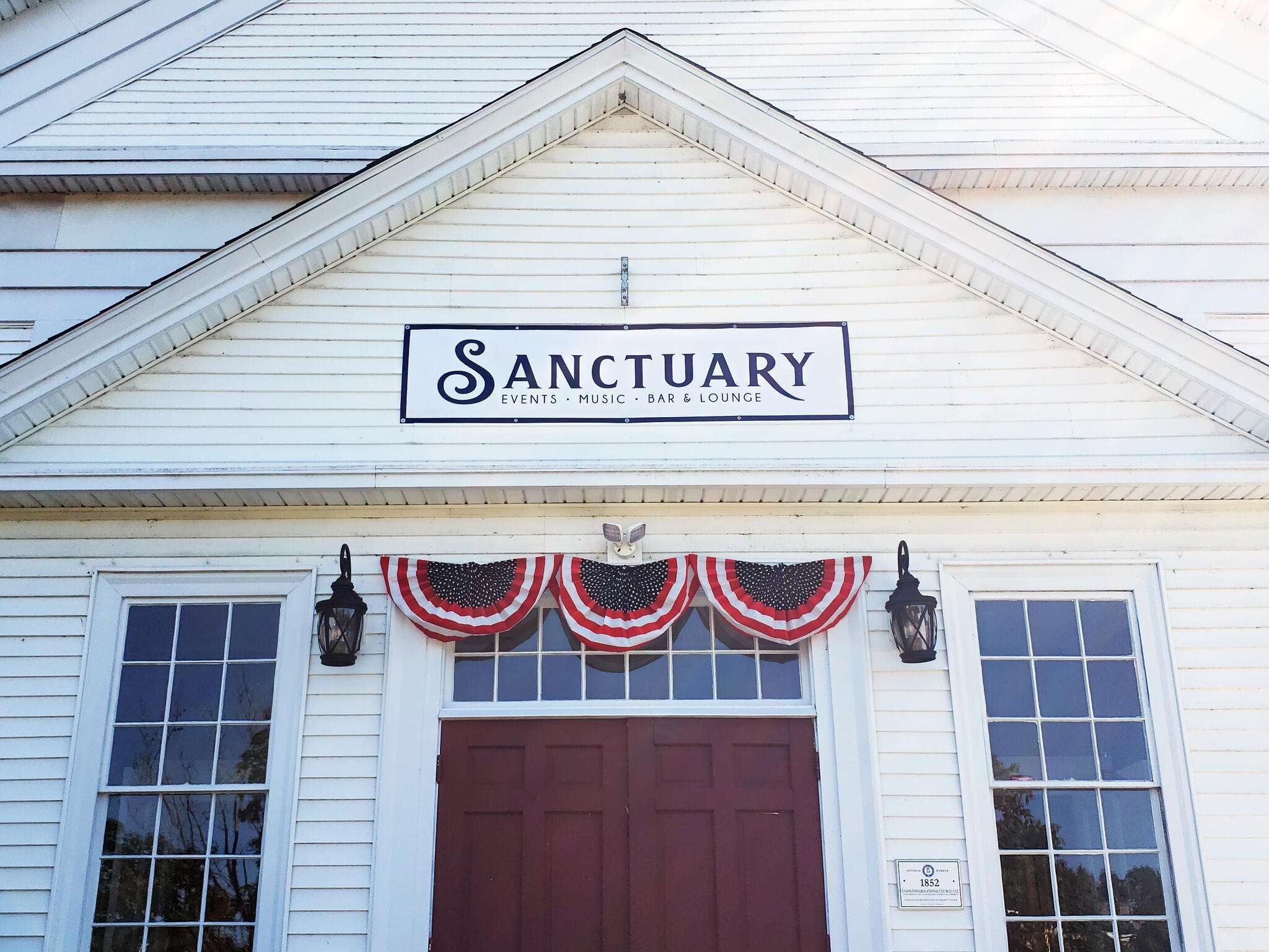 a white building with a sign that says sanctuary