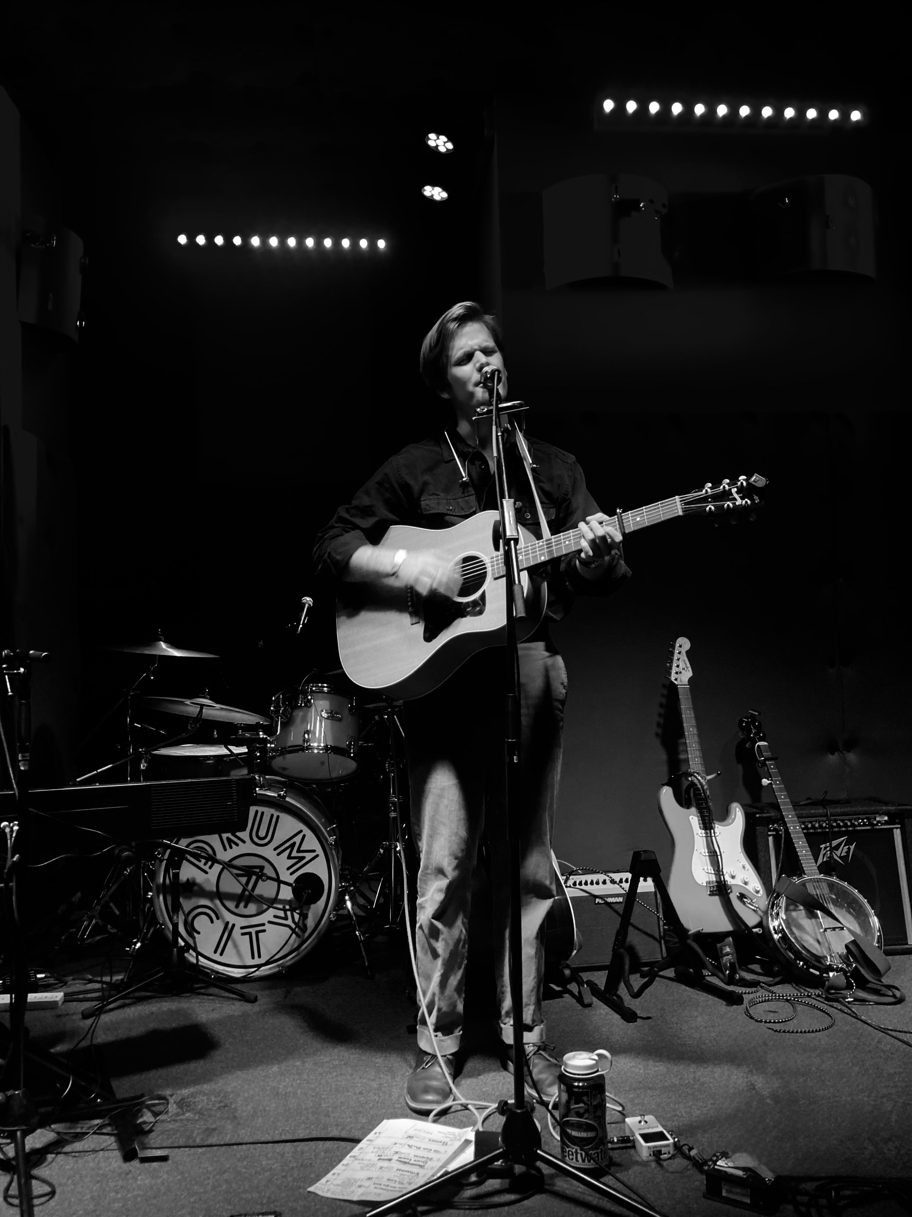 image may contain person, on stage, playing a musical instrument and night
