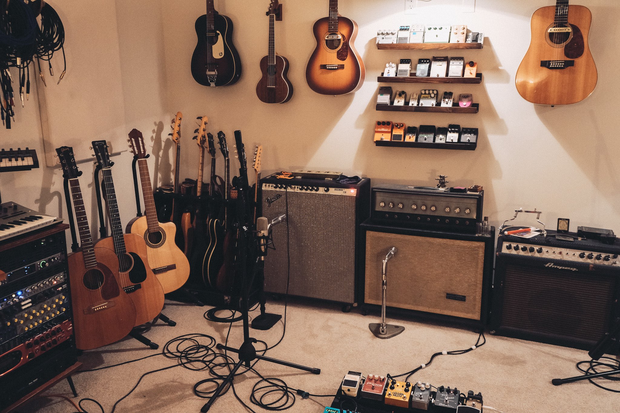a room full of guitars and other musical equipment
