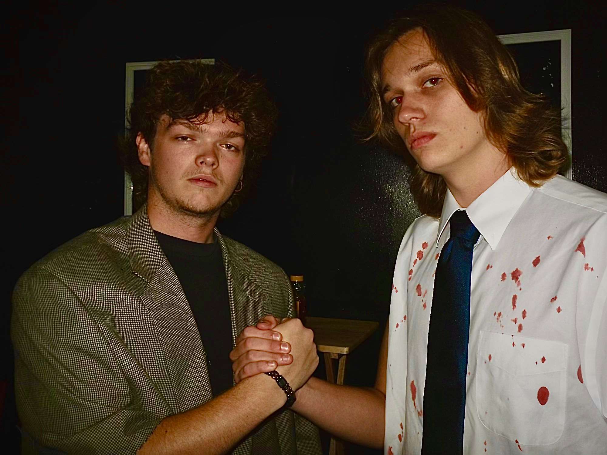 two men with blood on their hands