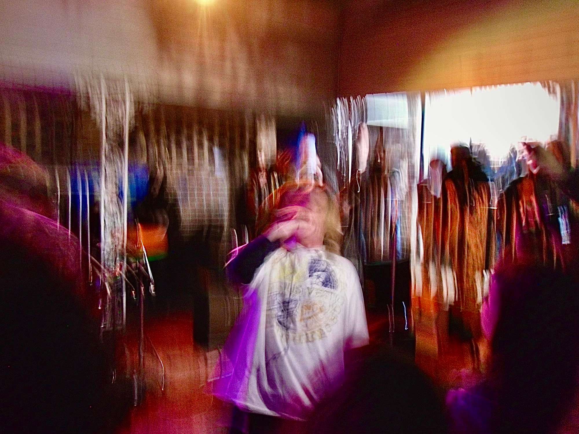 a blurry image of a person standing in front of a crowd