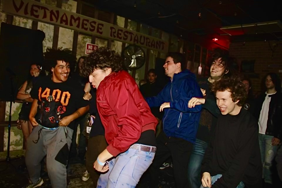 a group of people dancing in a dark room