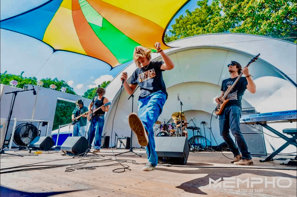 a group of people on stage with a colorful umbrella
