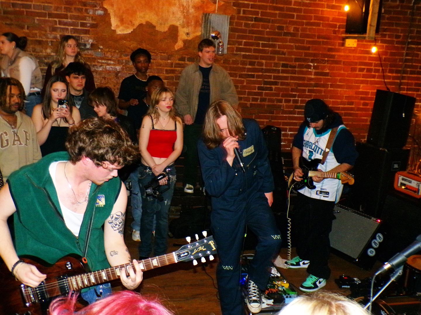 a group of people standing in front of a stage with guitars