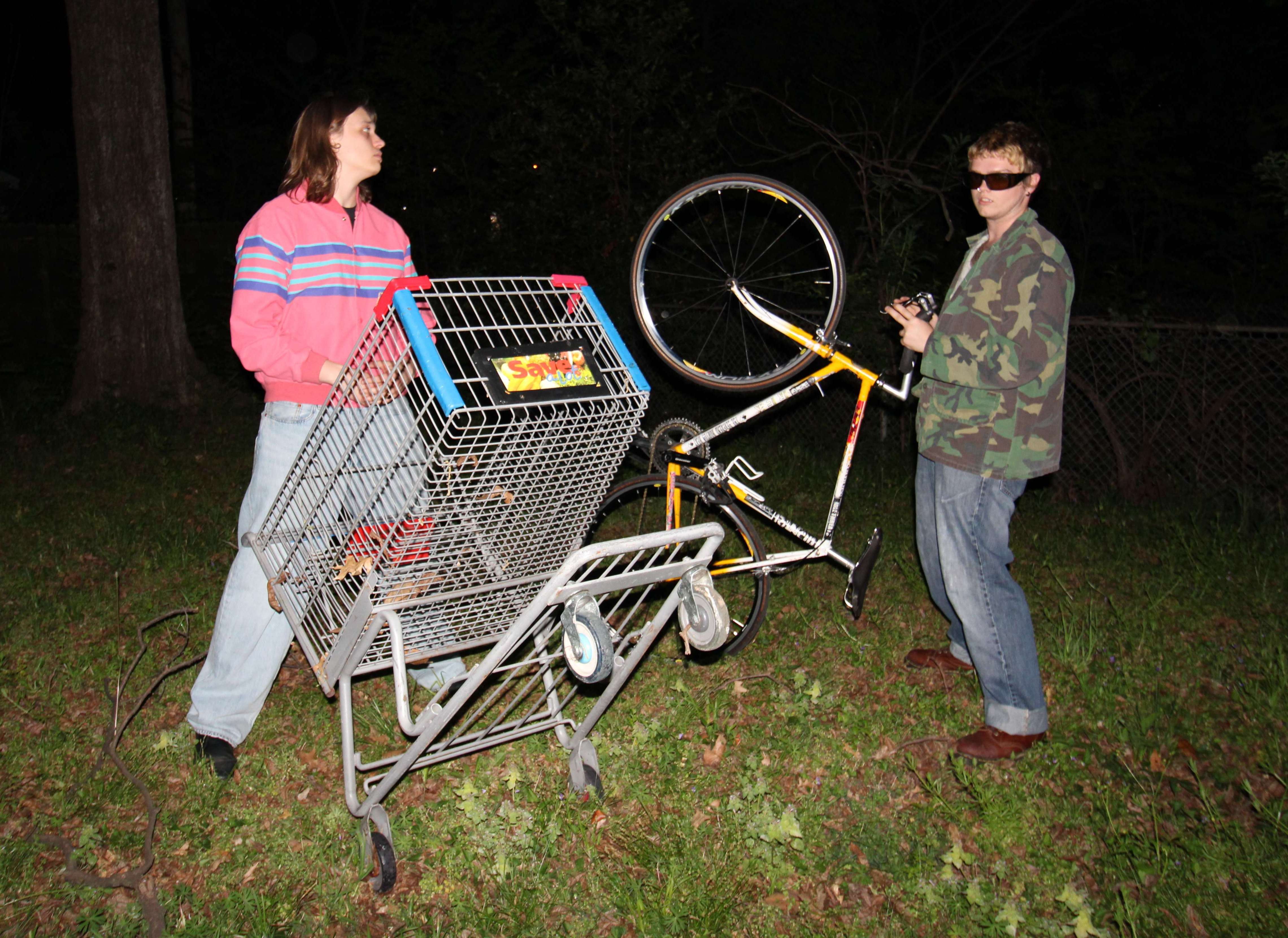 a man and a woman standing next to a shopping cart